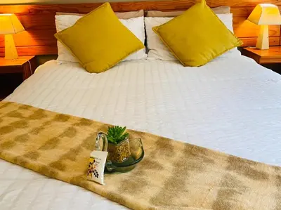 a bed with a tray with a pineapple on it at Hazyhaven Guest House in Hazyview