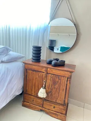 a mirror on top of a dresser next to a bed at 2 Bedroom Cottage sleeps maximum 4 Buhlebendalo in Benoni