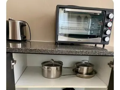a counter with two pots and a toaster oven at 2 Bedroom Cottage sleeps maximum 4 Buhlebendalo in Benoni