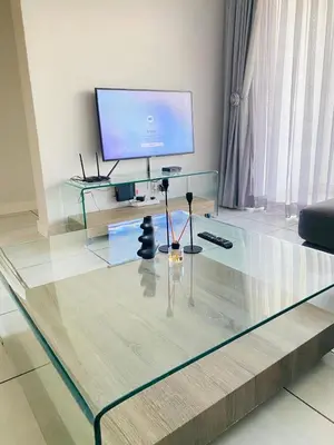 a glass coffee table in a living room with a tv at The Blyde SUPER STAR in Pretoria