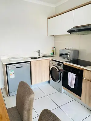 a kitchen with a washing machine and a dishwasher at The Blyde SUPER STAR in Pretoria