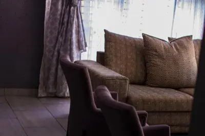a living room with a couch and two chairs at Thulamahashe Guest farm in Thulamahashi