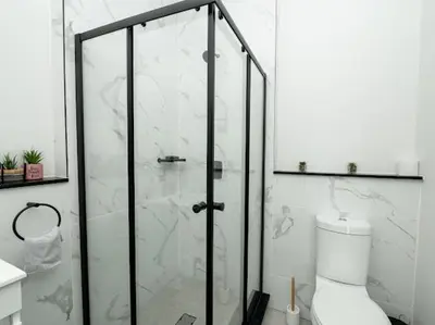 a bathroom with a glass shower with a toilet at 347 Waterfall Penthouse in Midrand