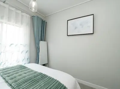 a bedroom with a bed and a picture on the wall at 347 Waterfall Penthouse in Midrand