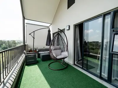 a porch with a hammock on a balcony at 347 Waterfall Penthouse in Midrand