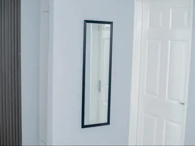 a mirror on a wall next to a door at Silalise Lodge in Burgersfort