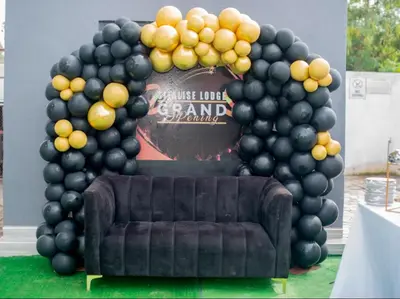 a large arch with black balloons and a couch at Silalise Lodge in Burgersfort