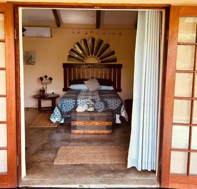 a bedroom with a bed with a wooden headboard at The Windmill Country Retreat in Hazyview