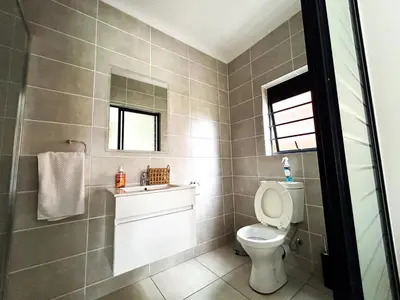 a bathroom with a toilet and a sink at The Blyde lagoon facing Pretoria in Pretoria
