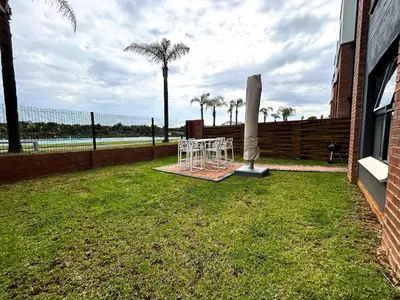 a table and chairs in a yard next to a building at The Blyde lagoon facing Pretoria in Pretoria
