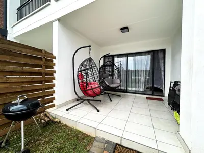 two chairs on a patio with a window at The Blyde lagoon facing Pretoria in Pretoria