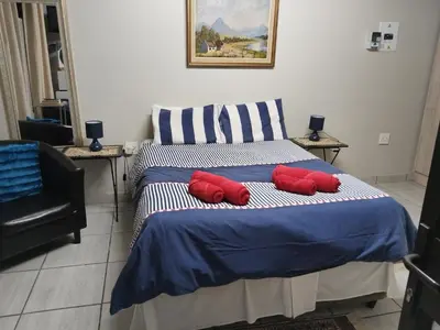 a bedroom with a bed with two red pillows on it at Kreuz in Evander