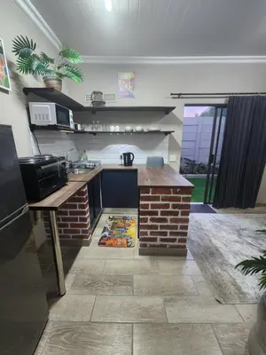 a kitchen with a sink and a counter top at Ode to Serenity Cottage in Pretoria