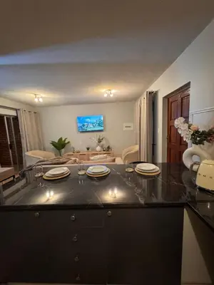 a kitchen with a table with plates on it at Centurion La Creme Apartment II in Centurion