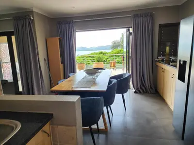 a kitchen with a table with a laptop on it at BondMakers Blue Canoe in Hartbeespoort