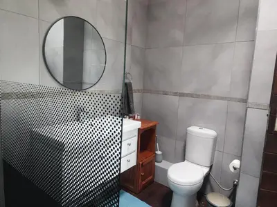 a bathroom with a toilet and a sink and a mirror at BondMakers Blue Canoe in Hartbeespoort