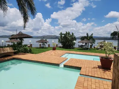a swimming pool with a view of the water at BondMakers Blue Canoe in Hartbeespoort