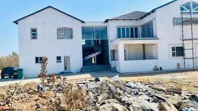 a house with a pile of rubble in front of it at 114 Zinnia Road in Midrand