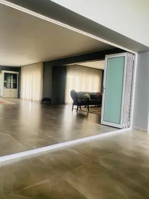 a living room with a couch and a glass door at 114 Zinnia Road in Midrand