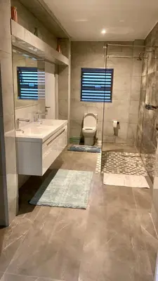 a bathroom with a toilet and a sink and a shower at 114 Zinnia Road in Midrand