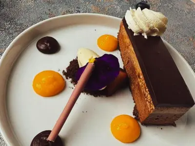 a piece of cake on a plate with oranges at Kruger Island Resort in White River