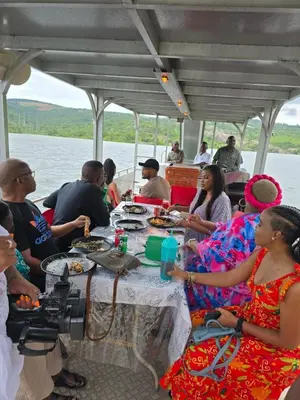 a group of people sitting around a table on a boat at Kruger Island Resort in White River