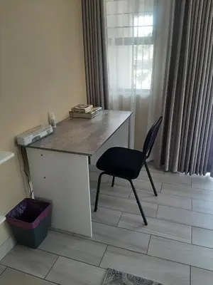 a desk with a chair in a room with a window at Bustani 1 Self Catering Studio Minimum 2 Nights in Edenvale
