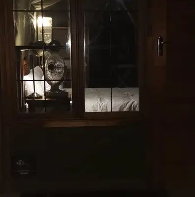 a room with a window with a fan and a bed at Sunset Game Farm in Mopane