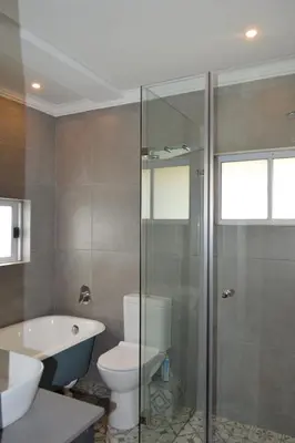 a bathroom with a shower and a toilet and a sink at 512 Berea in Pretoria