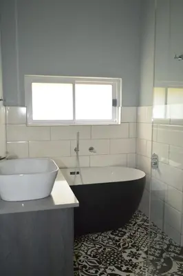 a bathroom with a tub and a sink and a window at 512 Berea in Pretoria
