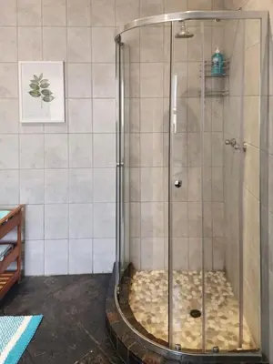 a shower with a glass door in a bathroom at Spies Villa - Fast Wi-fi, Netflix, DSTV, Solar, Certified Water System in Middelburg