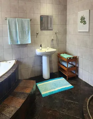 a bathroom with a sink and a bath tub at Spies Villa - Fast Wi-fi, Netflix, DSTV, Solar, Certified Water System in Middelburg