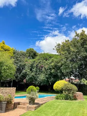 a backyard with a swimming pool and trees at Spies Villa - Fast Wi-fi, Netflix, DSTV, Solar, Certified Water System in Middelburg