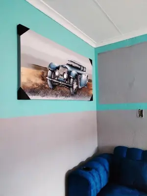 a wall with a picture of a car on it at Reutlwane Gardens B&B in Secunda
