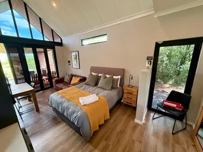 a bedroom with a bed and a couch at Spasie 30 Harties in Hartbeespoort