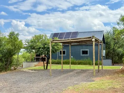 a house with solar panels on the roof at Spasie 30 Harties in Hartbeespoort