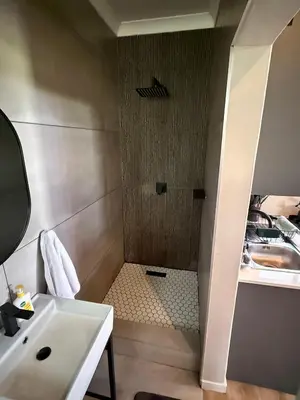 a bathroom with a shower with a sink at Spasie 30 Harties in Hartbeespoort