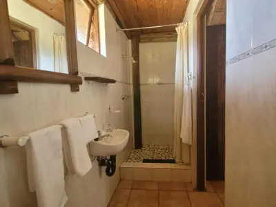 a bathroom with a sink and a shower at Lush Horizons Game Lodge in Modimolle
