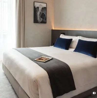 a bedroom with a large white bed with blue pillows at The Blyde lagoon Penthouse in Pretoria