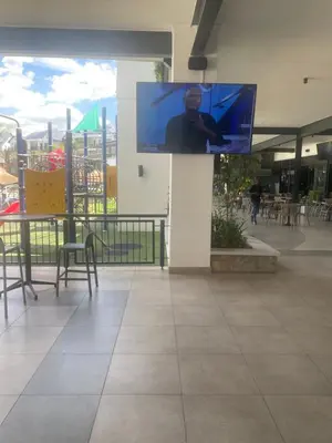 a flat screen tv on a wall in a mall at The Blyde lagoon Penthouse in Pretoria