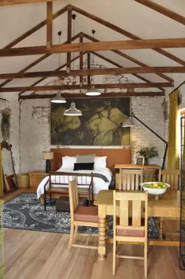 a room with a bed and a table and chairs at The Upper Room in Polokwane