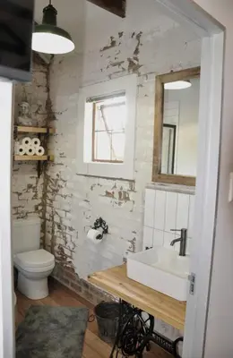 a bathroom with a sink and a toilet and a mirror at The Upper Room in Polokwane