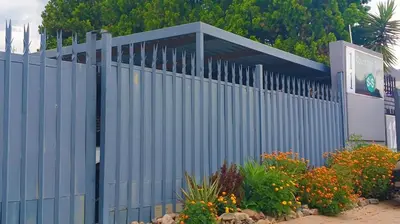 a blue fence with some plants and flowers at Eleven on Coulbrough in Midrand
