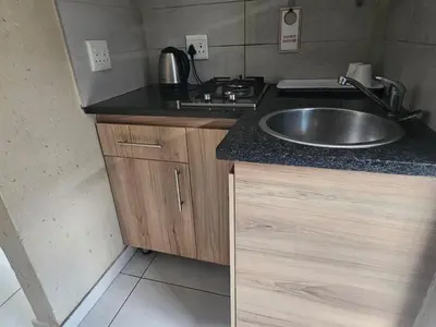 a kitchen with a sink and a counter top at Eleven on Coulbrough in Midrand