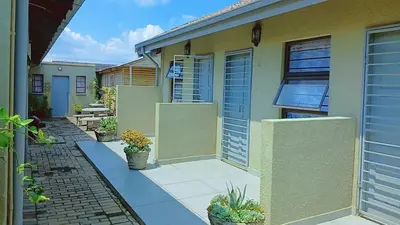 a house with a courtyard with potted plants on it at Eleven on Coulbrough in Midrand