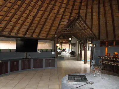 a pavilion with a tv in the middle of a room at Koro Lodge in Modimolle