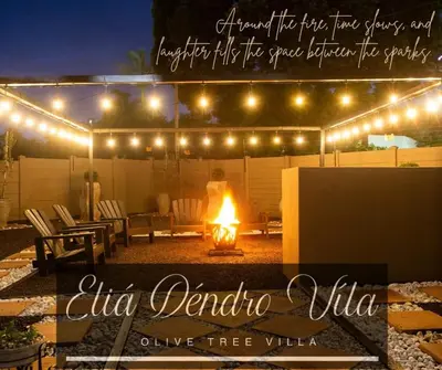 a person standing under a tent with a fire under lights at Eliá Dendró Víla in Lydenburg
