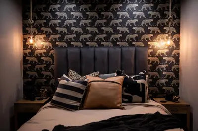 a bedroom with a bed with pillows on it at Eliá Dendró Víla in Lydenburg