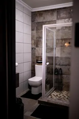 a bathroom with a toilet and a glass shower at Eliá Dendró Víla in Lydenburg