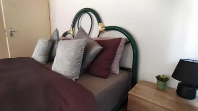 a couch with pillows on it in a bedroom at Nomads Rest in Sterkspruit